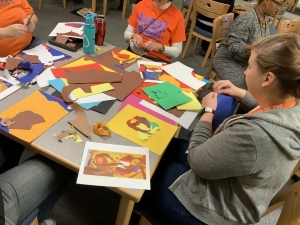 Teachers working on torn art works